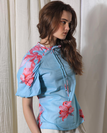 Rareism Women Kink Blue Cotton Fabric Short Sleeves Button Closure Tie-Up Neck Puff Sleeve Relaxed Fit Floral Print Top