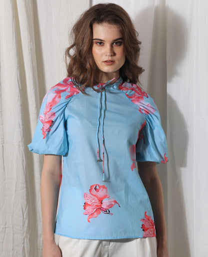 Rareism Women Kink Blue Cotton Fabric Short Sleeves Button Closure Tie-Up Neck Puff Sleeve Relaxed Fit Floral Print Top