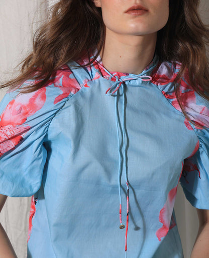 Rareism Women Kink Blue Cotton Fabric Short Sleeves Button Closure Tie-Up Neck Puff Sleeve Relaxed Fit Floral Print Top